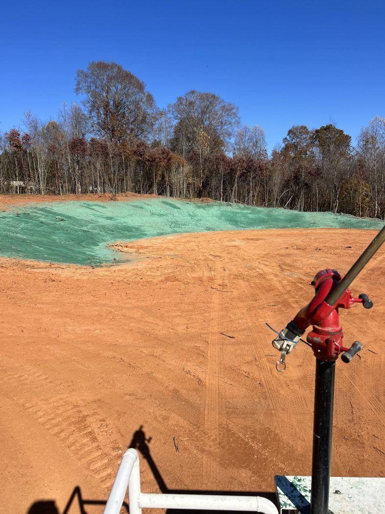 Raw red-clay slope before erosion control hydroseeding