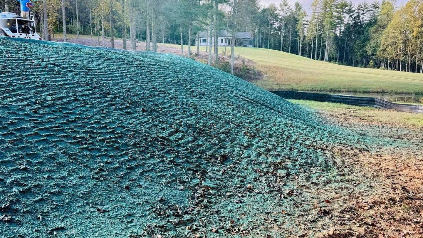 Hillside being hydroseed-sprayed