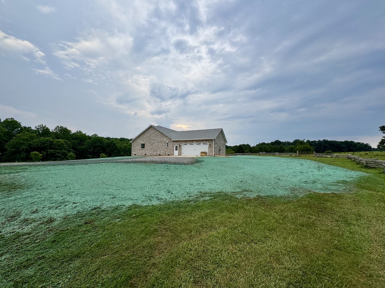 Brick farmhouse with a freshly hydroseeded hilltop lawn in the Catawba Valley NC