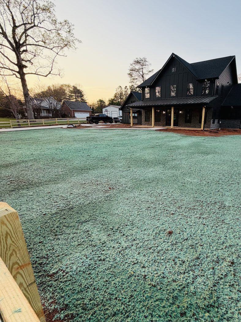 Farmhouse with a fresh hydroseeded lawn